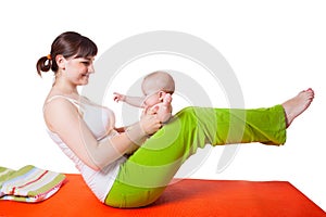 Young woman mother practicing yoga with baby