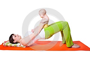 Young woman mother practicing yoga with baby