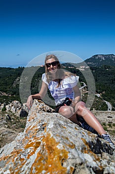 Young woman on mountain cliff