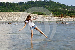 Young woman in mountain river