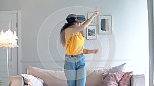 Young woman move arms, while wearing VR equipment.