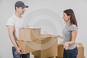 Young woman moving into new place, but she doesn`t understand why delivery guy brought her two cardboard boxes, which