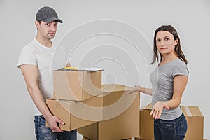 Young woman moving into new place, but she doesn`t understand why delivery guy brought her two cardboard boxes, which