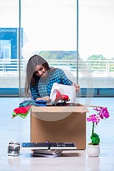 The young woman moving personal belongings