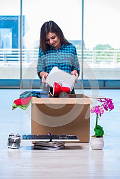 The young woman moving personal belongings