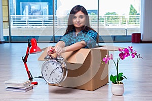 The young woman moving personal belongings