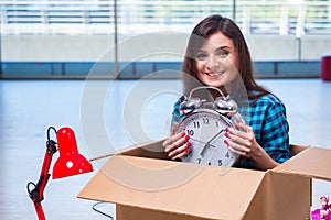 The young woman moving personal belongings