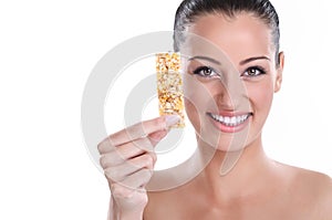 Young woman with muesli bar photo