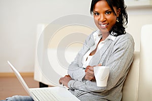 Young woman with a mug looking to you