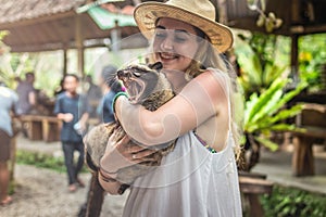 Young woman with musang coffee kopi luwak producer. Bali island.