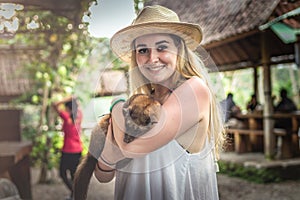 Young woman with musang coffee kopi luwak producer. Bali island.