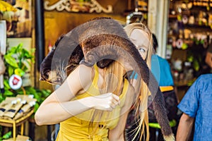 Young woman with musang coffee kopi luwak producer. Bali island