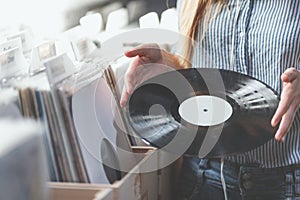 Young woman with music records indoors