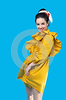 Young woman in a mustard dress looking romantic