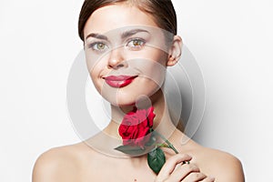 Young woman naked shoulders Clear skin smile red lips rose flower charm light