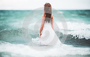 Young woman in nature with beautiful sea and blue sky. Summer vacation and travel concept. Dream and imagination