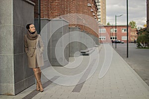 Young woman near a brick wall