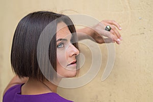 Young woman near old wall.pfoto