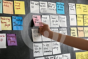 Young woman near scrum task board in office