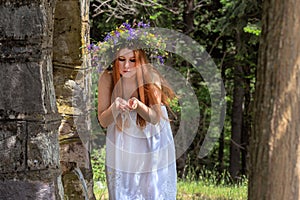 Young woman near the source in the mountains