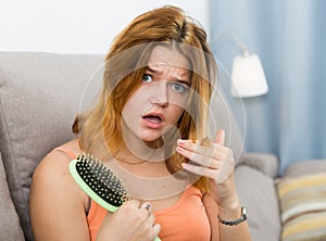 Young woman is nervous because her hair suffers from avitaminosis