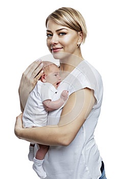 Young woman with a newborn baby in her arms. Smiling beautiful blonde with her daughter 1 week old. Motherhood and care. Isolated
