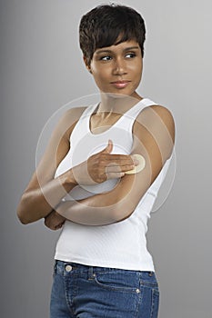 Young Woman With Nicotine Patch On Arm photo