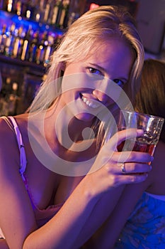 Young woman in nightclub smiling at camera