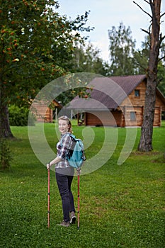 Young woman with nordic walk pols photo