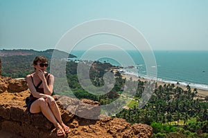 Young woman in North Goa, India. Top view of Vagator Beach