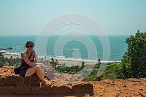 Young woman in North Goa, India. Top view of Vagator Beach