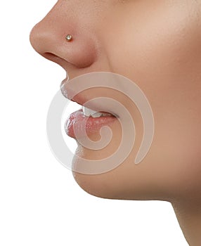 Young woman with nose piercing on white background, closeup