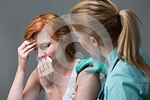 Young woman with nosebleed