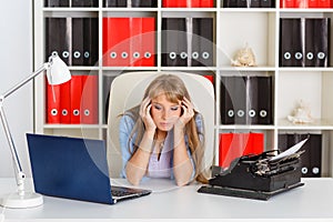 Young woman with notebook and typewriter.