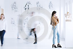 Young woman observing sculpture