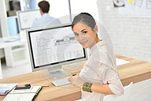 Young woman office worker by the desktop computer