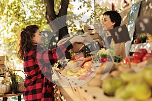 Young woman oing purchases at local farmers market