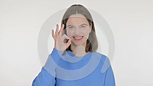 Young Woman with Ok Sign on White Background