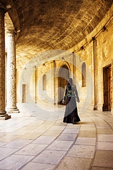 Young woman in old corridors
