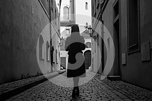 Young woman in old europian city in black and white colors photo