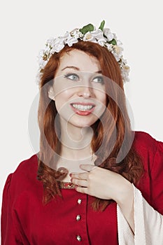 Young woman in old-fashioned princess costume looking away against gray background