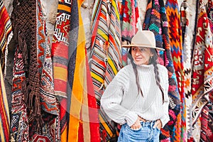 Old traditional Turkish carpet shop in cave house Cappadocia, Turkey Kapadokya. Young woman on vacation in Turkey