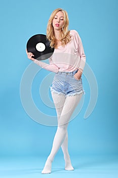 Young woman with old vinyl record