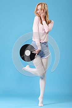 Young woman with old vinyl record