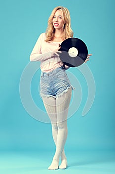 Young woman with old vinyl record