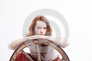 Young woman with an old wagon wheel