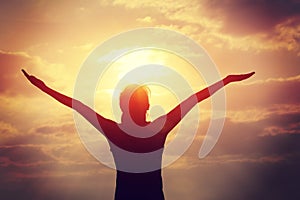 Young woman open arms on sunrise beach