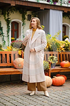 Young woman with open coat at pumpkin festival