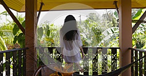 Young Woman Open Door Walking Out On Summer Terrace With Beautiful Tropical Landscape, Back Rear Of Beautiful Girl Enjoy