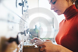 Young woman open file catalog box